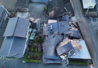 Days after Japan’s quake, a family shelters in their car in sweltering heat